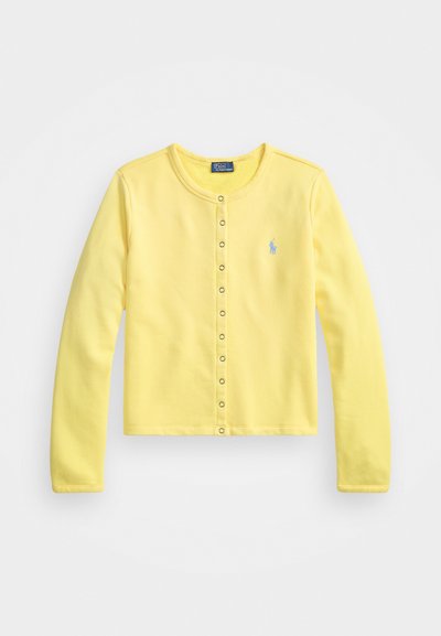 Yellow long-sleeve cardigan made of soft cotton. Features a round neckline, front button closure with silver snaps, and a small blue logo.