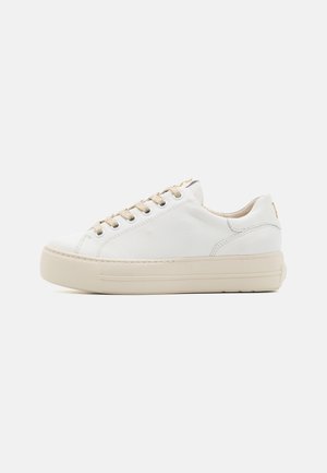 White low-top leather sneaker with beige laces and thick beige sole, shown from the side on a plain light background.
