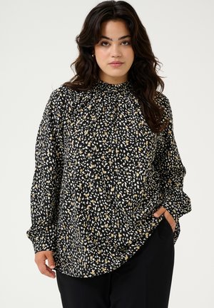 Zwarte blouse met een hoge hals, voorzien van een verspreid wit en gouden abstract patroon. Lange mouwen met een losse pasvorm en een ronde zoom.