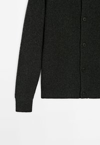 Dark gray ribbed cardigan featuring long sleeves, a buttoned front, and a textured fabric. Flat lay view showcases the stitching detail.