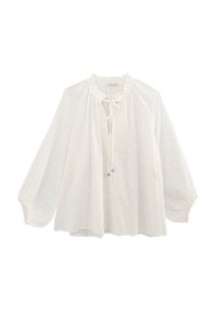Blusa bianca in tessuto leggero, con motivo a pois, colletto a volan, frontale con coulisse e maniche lunghe e svasate.