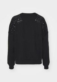 Sudadera negra de tejido suave, con mangas largas y adornos de lentejuelas en los hombros. Puños y dobladillo acanalados.