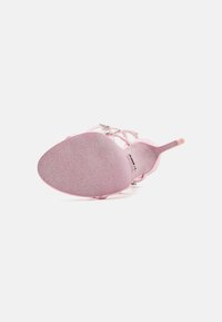 Pink high-heeled sandal with a smooth, shiny upper, delicate straps, and a textured sole. Features decorative metallic accents.