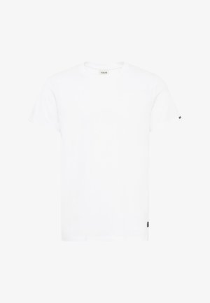 Balta medvilninė marškinė su apvaliu iškirpimu, trumpomis rankovėmis ir tiesiu siluetu. Ant kairės rankovės yra mažas juodas logotipas.