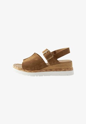 Brown suede wedge sandal with a textured wooden sole, white rubber platform, and a strap with a metal buckle for adjustment.