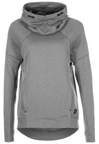 Grå Nike huvtröja med hög krage, raglanärmar och sidoflikar. Tillverkad av mjukt material, med en diskret svart logotyp vid fållen.