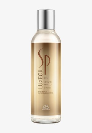 Luksuriøs guldbelagt flaske af Wella SP Luxe Oil Keratin Protect let shampoo med sølvkappe til hårrensning og beskyttelse.