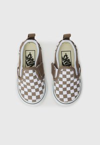Hnedé a biele kockované slip-on topánky s textúrovaným textilným zvrškom, elastickými postrannými doplnkami a bielou gumovou podrážkou.