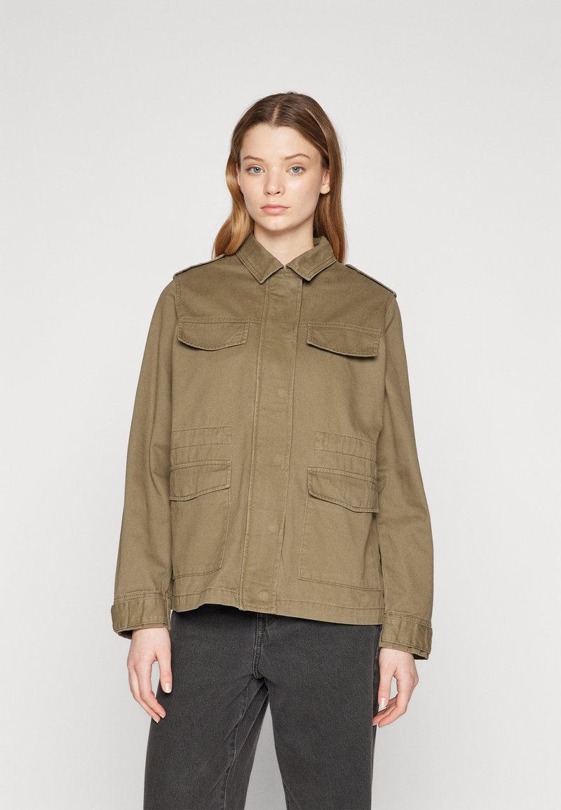 Olive green military-style jacket made of cotton. Features two chest pockets and two side pockets, with a collared neckline and button closure.