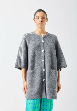 Gray wool cardigan with a relaxed fit, featuring oversized sleeves, a round neckline, and four white buttons. Includes two front pockets.