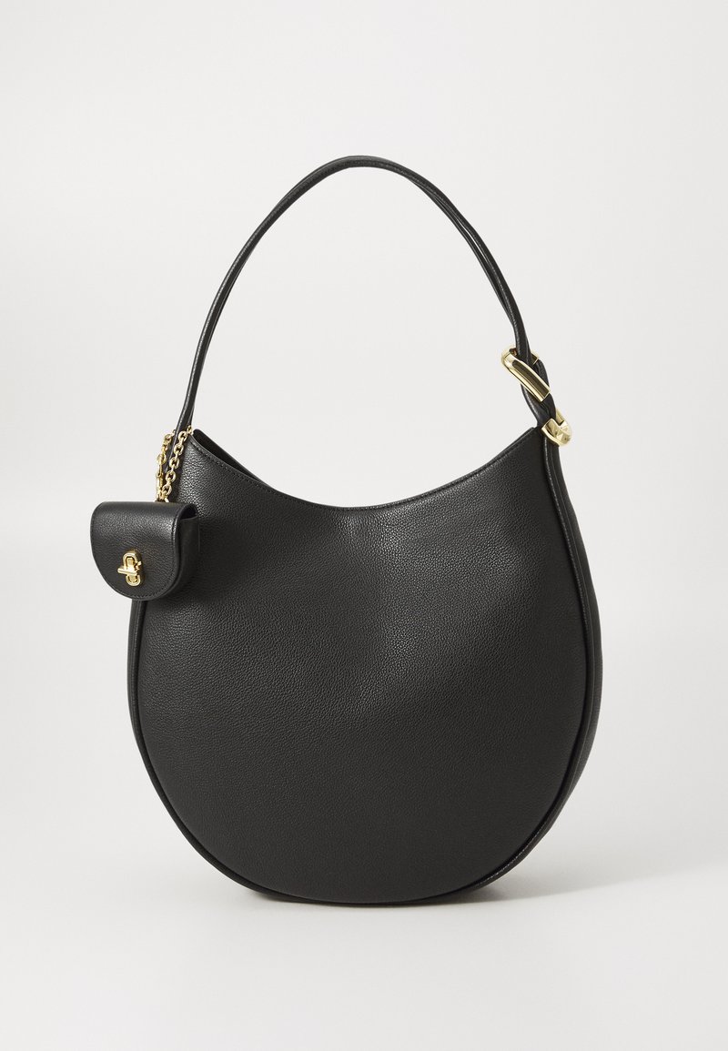 Black leather hobo bag with a curved shape, textured surface, gold hardware, and a small flap pocket attached by a chain.