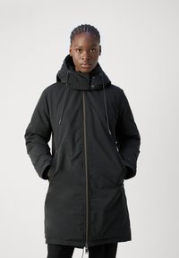 Black padded coat with a high collar and adjustable drawstring hood. Featuring a front zipper and side pockets, and a smooth texture.