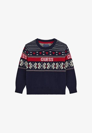 Pull en maille bleu marine avec des motifs géométriques et floraux rouges et blancs, avec le texte "GUESS" sur la poitrine et les manches.