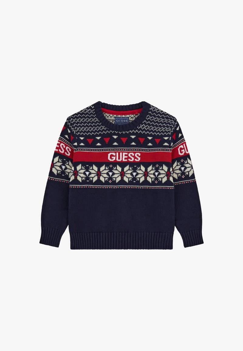 Pull en maille bleu marine avec des motifs géométriques et floraux rouges et blancs, avec le texte "GUESS" sur la poitrine et les manches.