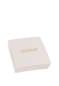 Kvadratisk blush-färgad låda med rundade kanter, som har ordet "amor" i guldtext på locket. Slät, matt yta.