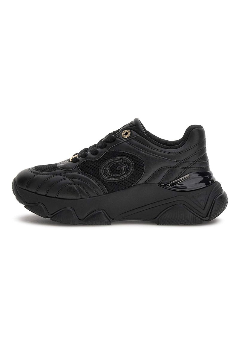 Black chunky sneaker with textured leather and mesh panels, rounded toe, thick sole, and metallic logo detail on side and laces.