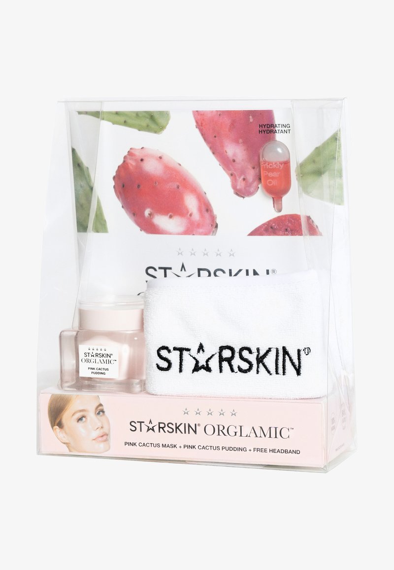STARSKIN hudpleiesett som inneholder et hvitt hodebånd, rosa kaktuspudding i et klart glass, og en serumkapsel, alt i en gjennomsiktig boks.