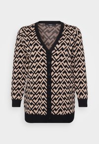 Knitted cardigan in beige and black, featuring a zigzag pattern, V-neck design, long sleeves, and six black buttons down the front.