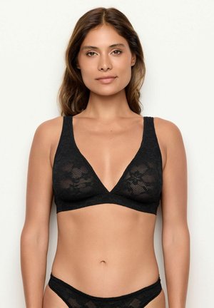 Bralette in pizzo nero con scollatura a V, spalline larghe e motivo floreale. Tessuto morbido, senza fodera e con una finitura leggera.