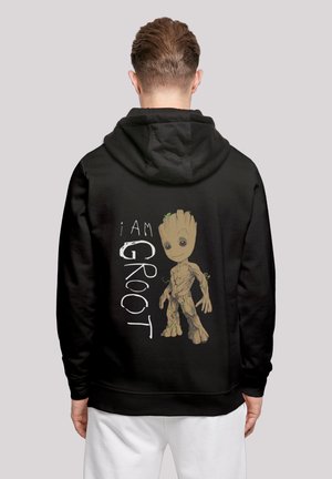 Black hoodie featuring a cartoon character with a tree-like design, labeled "I AM GROOT" in white, with green accents and detailed textures.
