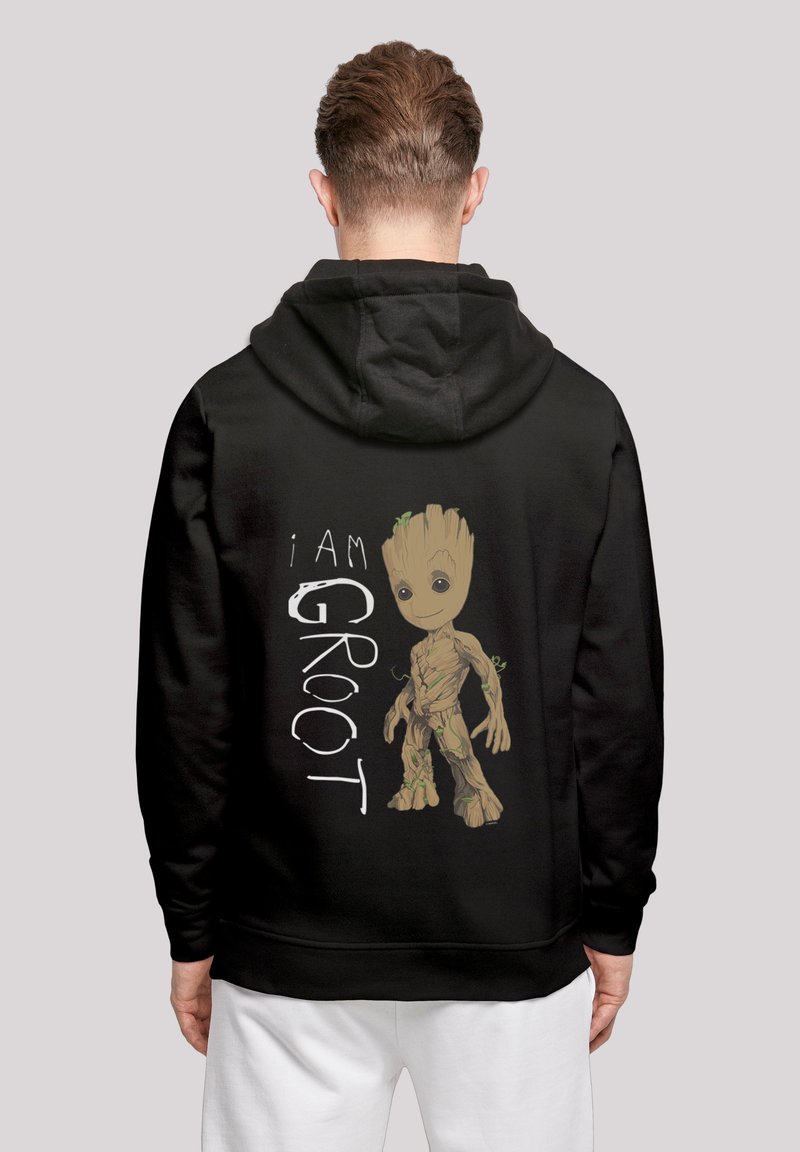 Svart hettegenser med en tegneseriefigur som har et treaktig design, merket "I AM GROOT" i hvitt, med grønne aksentfarger og detaljerte teksturer.
