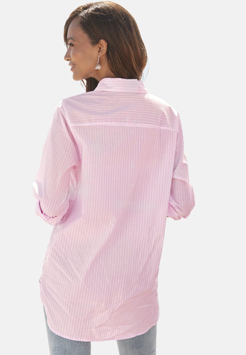 Light pink striped shirt with long sleeves, a soft texture, and a curved hem. Features a back yoke and button cuffs.