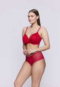 Ensemble de lingerie rouge comprenant un soutien-gorge rembourré lisse avec des bretelles ajustables et une culotte taille haute assortie avec des accents en dentelle.