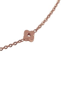 Rose gold -värinen ketjuhihna, jossa on kukka-muotoinen riipus keskireiällä, sileä pinta ja toisiinsa kytkeytyviä lenkkejä.