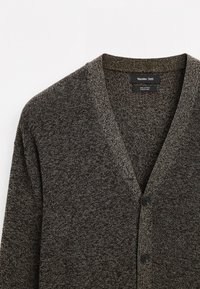 Gray cotton cardigan featuring a V-neck, black buttons, and a soft, textured knit design. Labels are visible inside the collar.