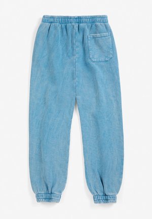 Lyseblå bløde sweatpants med elastisk talje, elastiske manchetter og en baglomme på højre side.