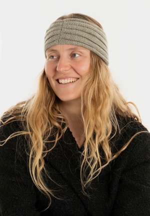 Gray knitted headband with three horizontal ribbing patterns, made of soft material. Worn by a person with long, wavy hair.