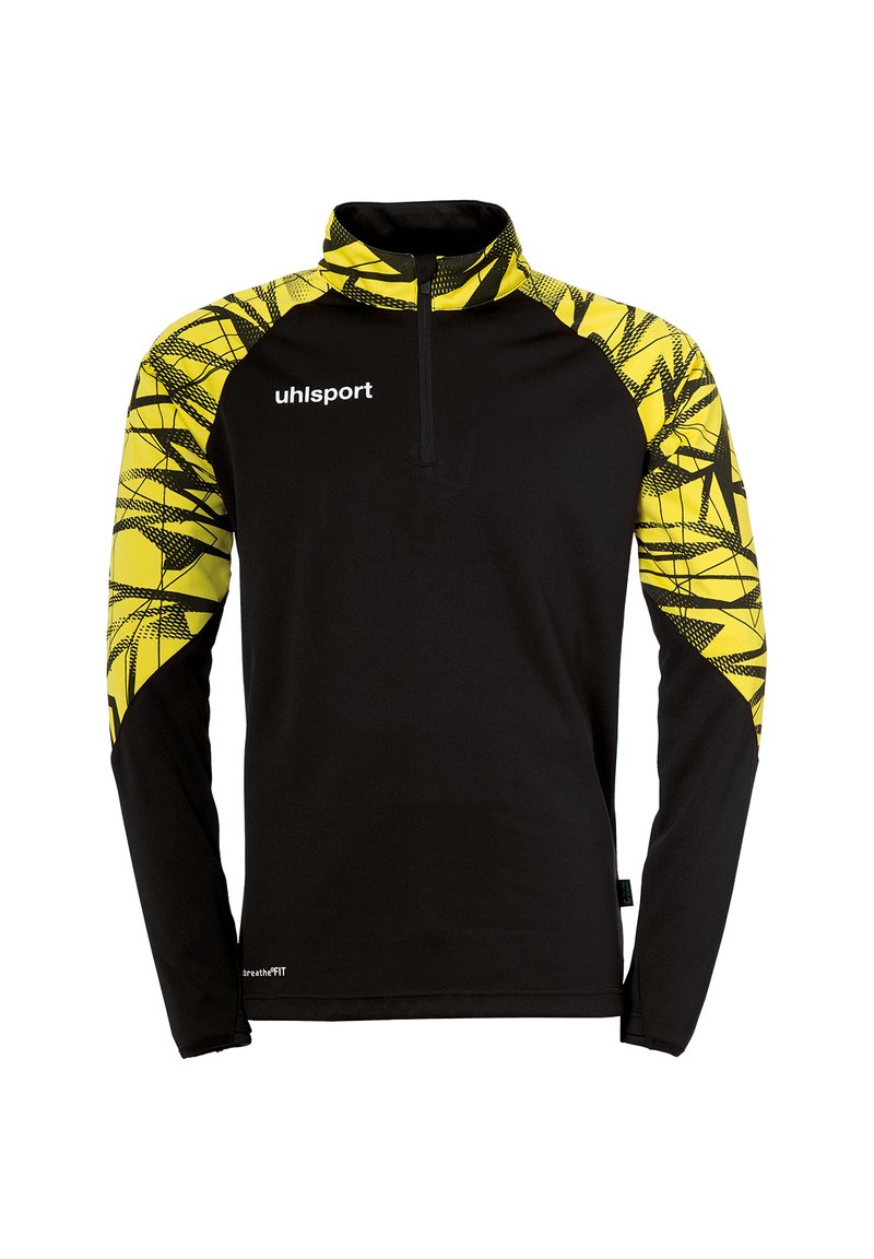 Zwarte lange mouw pullover met een halve rits kraag. Heeft een gele geometrische patroon op de schouders. Het materiaal lijkt glad en lichtgewicht te zijn.
