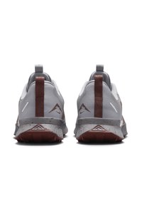 Grey athletic shoes featuring a breathable mesh upper, textured finish, brown accents, and a speckled outsole.