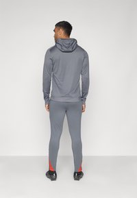 Nike Performance STRIKE PANT - Tréningruha alsók - iron grey/dragon red/white