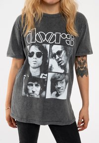 Gray cotton t-shirt featuring a front graphic with black and white photos of four male figures and the text "The Doors" in bold white lettering.