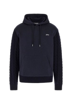 Tumesinine kapuutsiga sviiter, millel on heegeldatud varrukad, ees suur tasku, reguleeritav nööriga kapuuts ja logo detail rinnal. Pehme kangatunne.