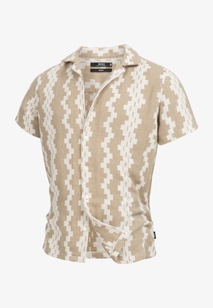 Tan short-sleeve shirt featuring a contrasting white zigzag pattern, button-down front, and woven texture. Designed for a medium fit.