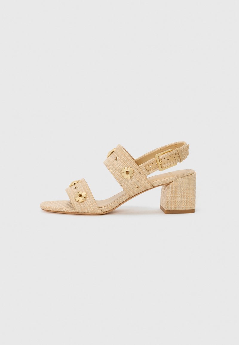 Beige heeled sandals with textured fabric, wide toe straps, gold floral accents, and ankle strap with buckle. Block heel design.