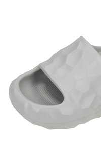 Gray slide sandal featuring a textured hexagonal pattern, open toe design, and a cushioned insole with a smooth inner surface.