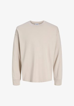 Koszulka z długim rękawem i okrągłym dekoltem w kolorze jasnobeżowym, wykonana z bawełny. Gładka faktura z prążkowanymi mankietami i luźnym krojem. Brak widocznych logo i wzorów.