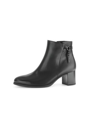 Bottine en cuir noir avec talon bloc, bande latérale et bout pointu, présentée sur un fond blanc.