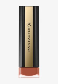 Huulipuna tyylikkäässä mustassa uritetussa putkessa, jossa on kultainen raita ja "MAX FACTOR X" -logo. Pohjassa on kiiltävä, läpinäkyvä osa ja korallinvärinen sävy.