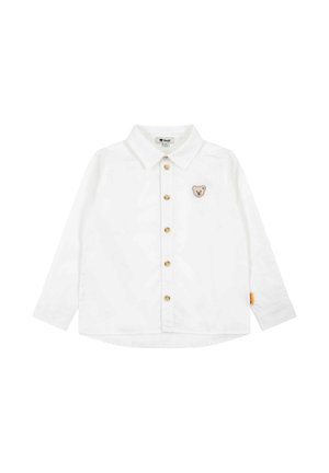 White long-sleeve button-up toddler shirt with collar and small teddy bear patch on the chest, featuring brown buttons.