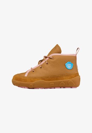 Brown leather ankle boot with pink accents, features textured suede, round laces, and a blue brand tag. Thick rubber sole with grip pattern.