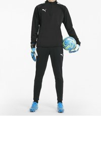 Sort langærmet atletisk top med halvlukning, matchende bukser, blå og grøn fodbold, blå støvler og handsker med hvide detaljer.