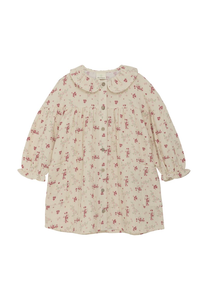 Blomsterprintet kjole i lys beige med pink blomster. Har en rund krave, puffede ærmer, knaplukning og to sidelommer.