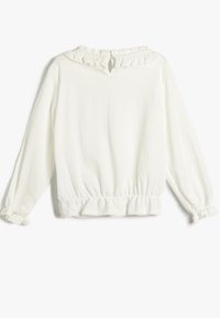 Blusa bianca a maniche lunghe realizzata in tessuto testurizzato. Presenta un colletto arricciato, una schiena con apertura a chiave e polsini e orlo elasticizzati.