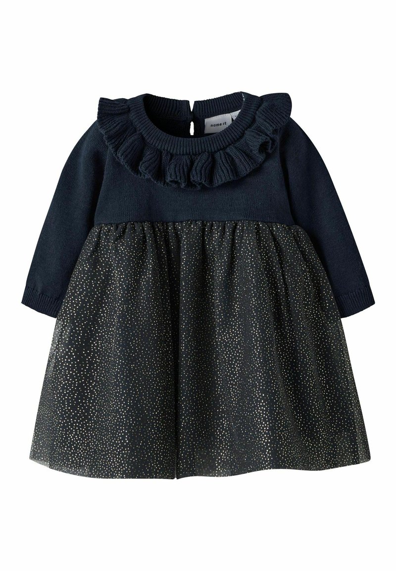 Tumes pikkade varrukatega kleit, millel on volangidega kaelus ja sädeleva kuldsete täppidega pitsseelik, tagant nööpide sulgemisega ja elastne korpus.