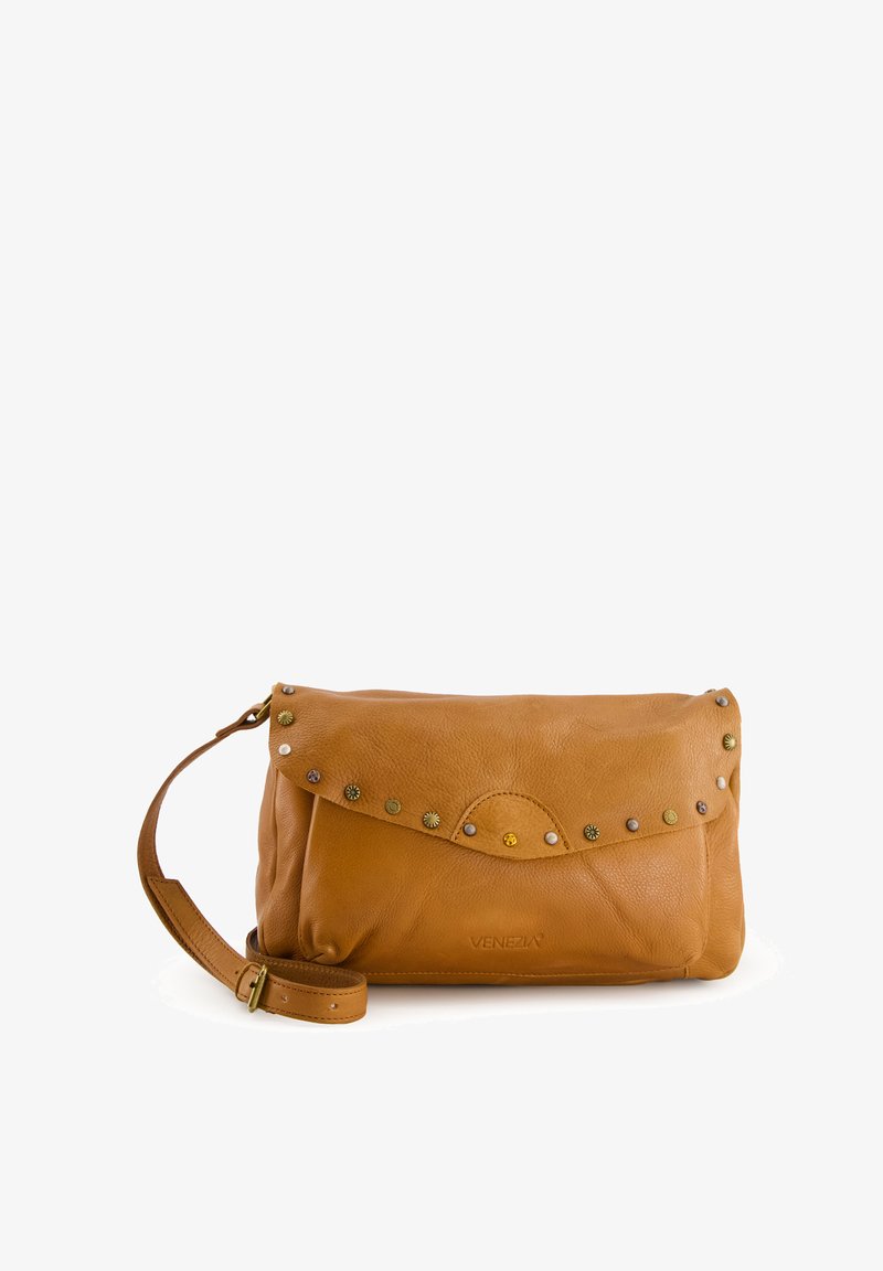 Leather clutch bag in tan color with a fold-over flap, decorated with metal studs, and a detachable strap. Smooth texture and rounded edges.