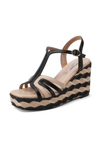 Sandali con zeppa neri e beige con suola in juta intrecciata, cinturini curvi e dettaglio con fibbia. Presentano un motivo testurizzato a zigzag sulla base.